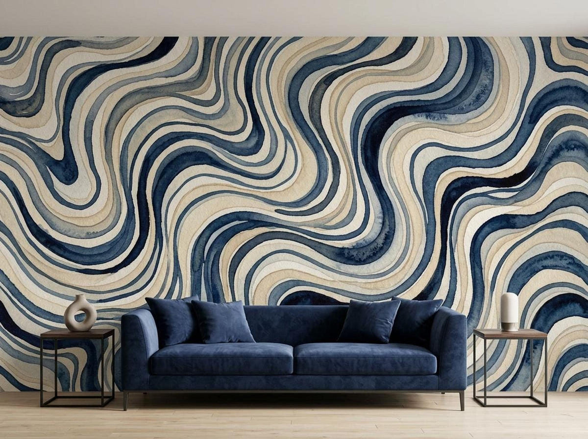 A large blue wavy watercolor wall mural behind a dark blue velvet sofa with side tables.