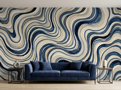 A large blue wavy watercolor wall mural behind a dark blue velvet sofa with side tables.