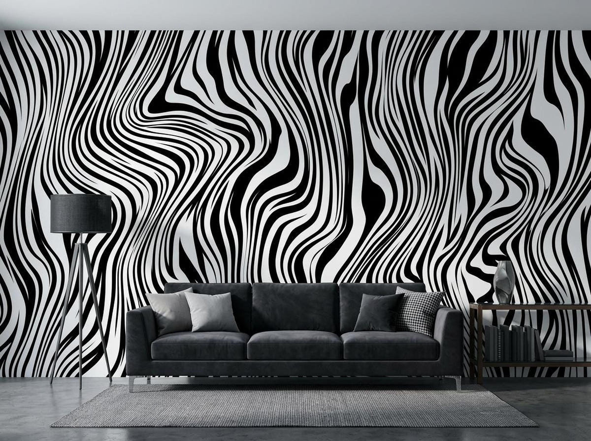 A living room interior features a black and white wavy line wallpaper accent wall behind a dark grey sofa with a lamp and rug.