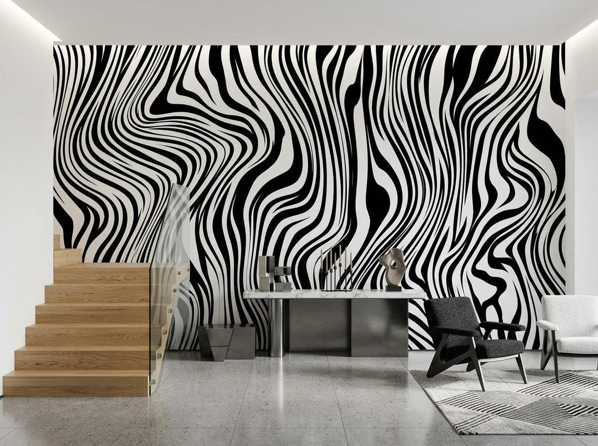 A hallway with wooden stairs and a sleek marble console table set against a bold black and white swirled wallpaper.