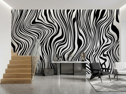 A hallway with wooden stairs and a sleek marble console table set against a bold black and white swirled wallpaper.