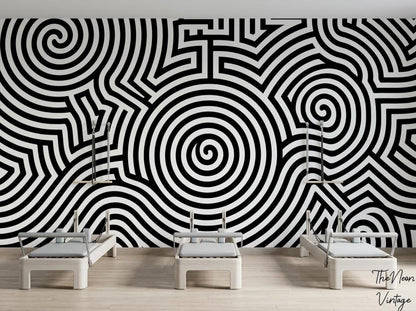 A fitness studio features three Pilates reformer machines positioned in front of a striking black and white spiral wallpaper mural.