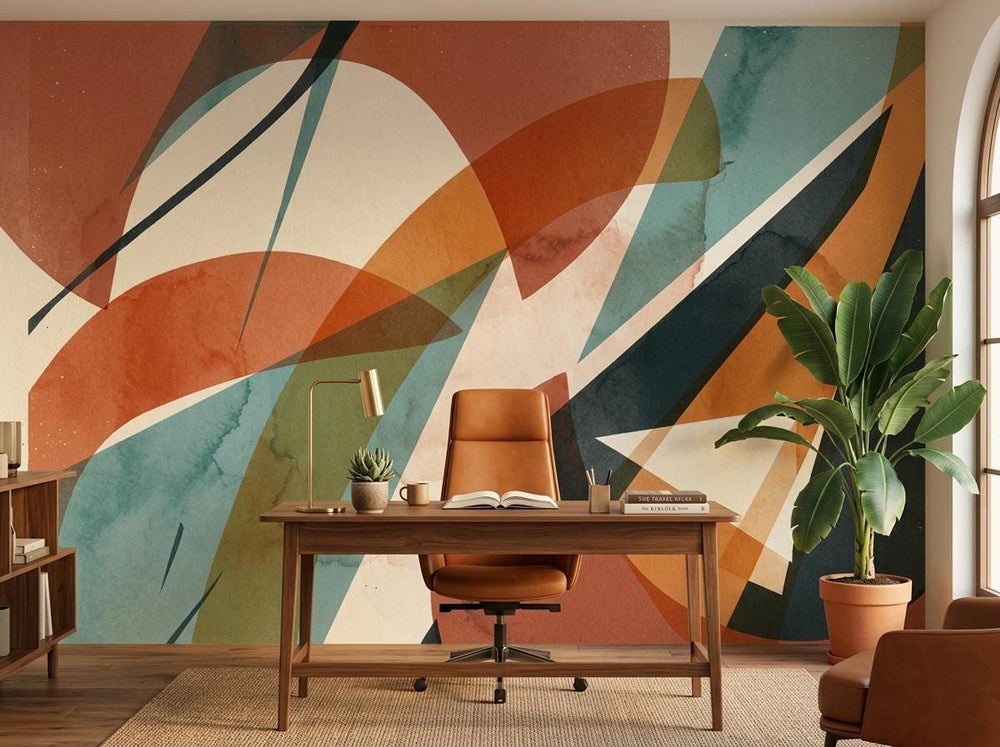 A home office featuring an abstract geometric terracotta wallpaper mural on the accent wall behind a wooden desk and chair.