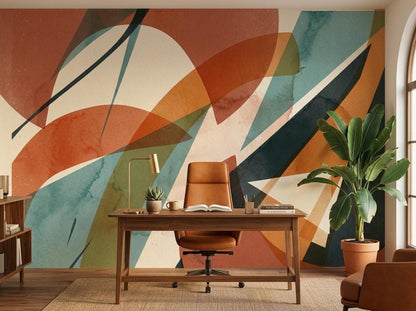 A home office featuring an abstract geometric terracotta wallpaper mural on the accent wall behind a wooden desk and chair.