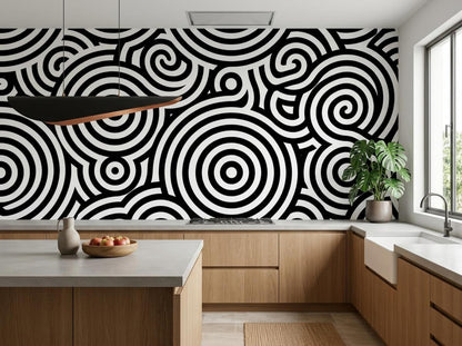 A modern kitchen with wooden cabinetry and countertops featuring a black and white swirl patterned wallpaper backsplash.