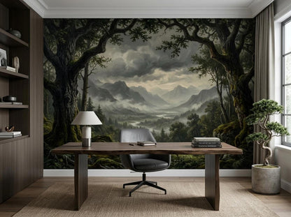 A home office featuring a moody forest and mountain landscape wallpaper mural on the wall behind a wooden desk.