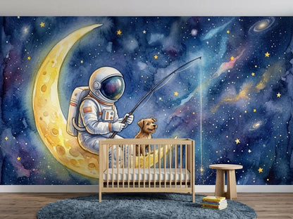 A nursery features a dark wood crib placed against a watercolor wall mural of an astronaut and a dog fishing on a crescent moon in a starry galaxy.