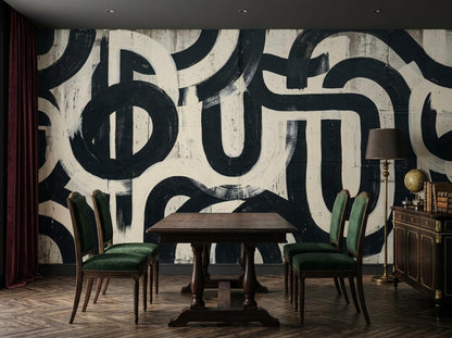 A dining area with a dark wooden table and green upholstered chairs against an abstract black and white brushstroke wall mural.