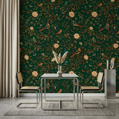 A dining space displays emerald green bird and flower wallpaper, a modern glass-top table with two rattan chairs, and a white curtain.