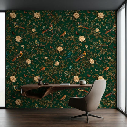 An office setup includes dark green chinoiserie wallpaper, a sleek modern wooden desk, and a tan upholstered swivel chair against a white window frame.