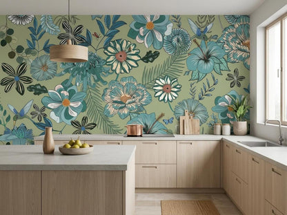 A modern kitchen with light wood cabinets and a marble countertop features a large sage green floral wallpaper accent wall in the background.