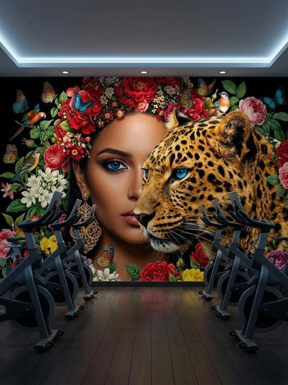 The maximalist leopard wall mural installed in a fitness room with several stationary exercise bikes on a dark wood floor.