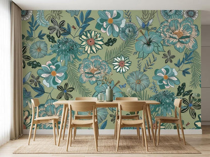 A wooden dining table and four chairs sit on a jute rug in front of a sage green botanical wallpaper mural with vintage blue flowers.