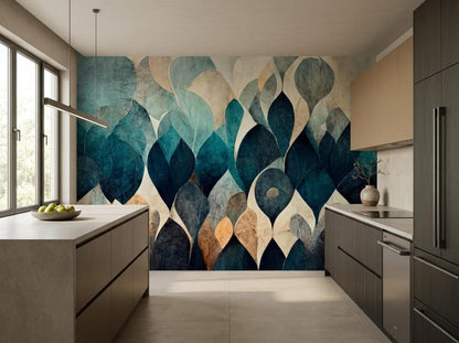 A kitchen with cabinets and counters centered around an accent wall of abstract teal and beige leaf mural wallpaper.