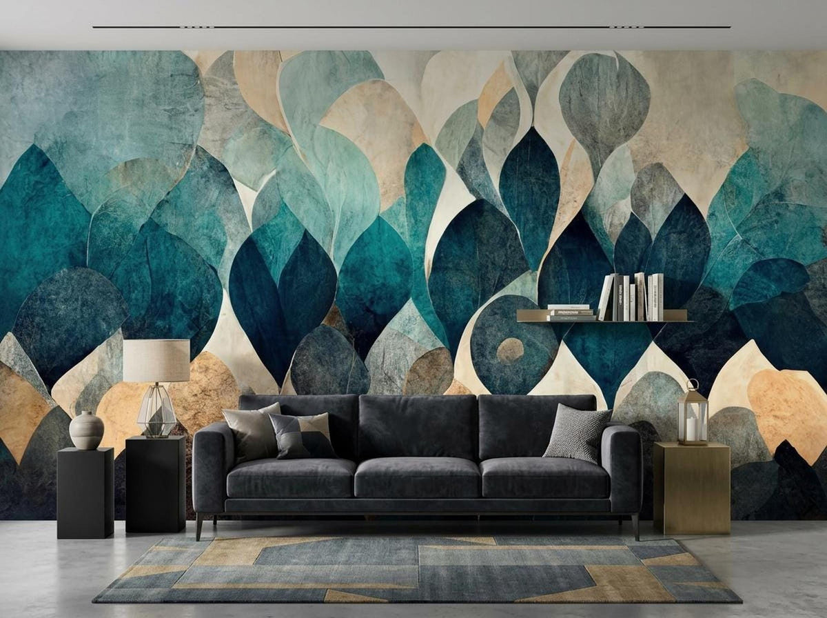 A living room with a dark gray sofa in front of an abstract teal and beige leaf mural wallpaper.