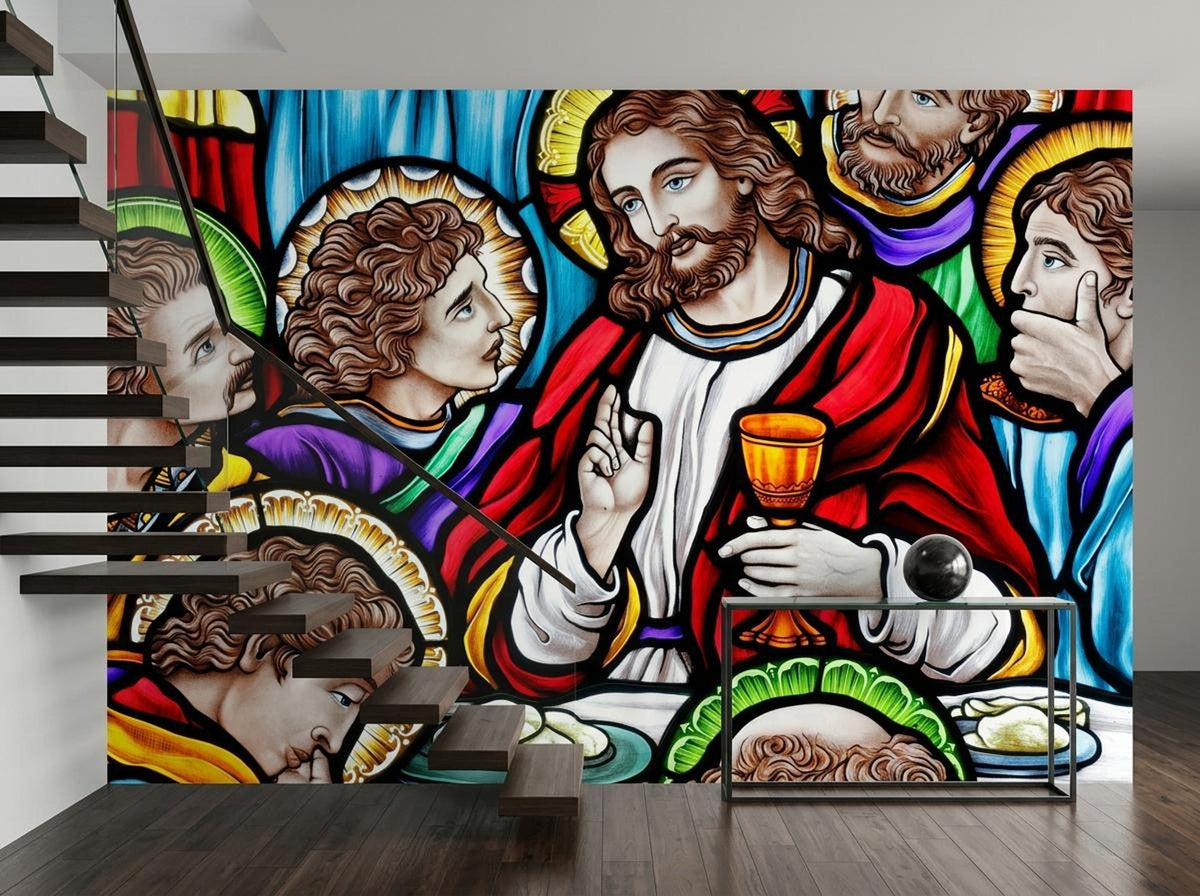 A stained glass wall mural showing the Last Supper with Jesus holding a chalice, partially obscured by a modern staircase.